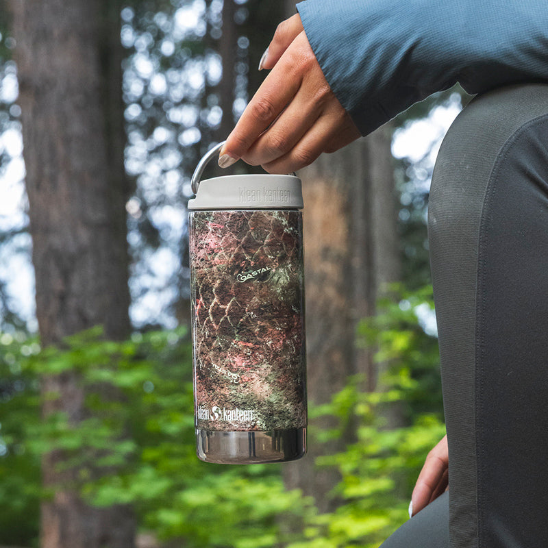 12oz-tkwide-with-twist-cap-mossy-oak-n1 12oz_tumbler_mossyoak_rainbowtrout_hand_closeup_square.jpg